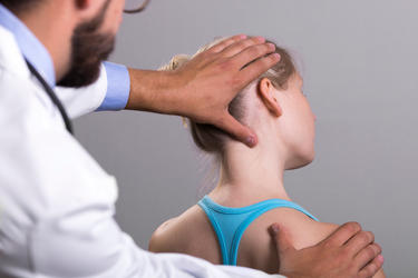 physiotherapist stretching the injured woman's neck